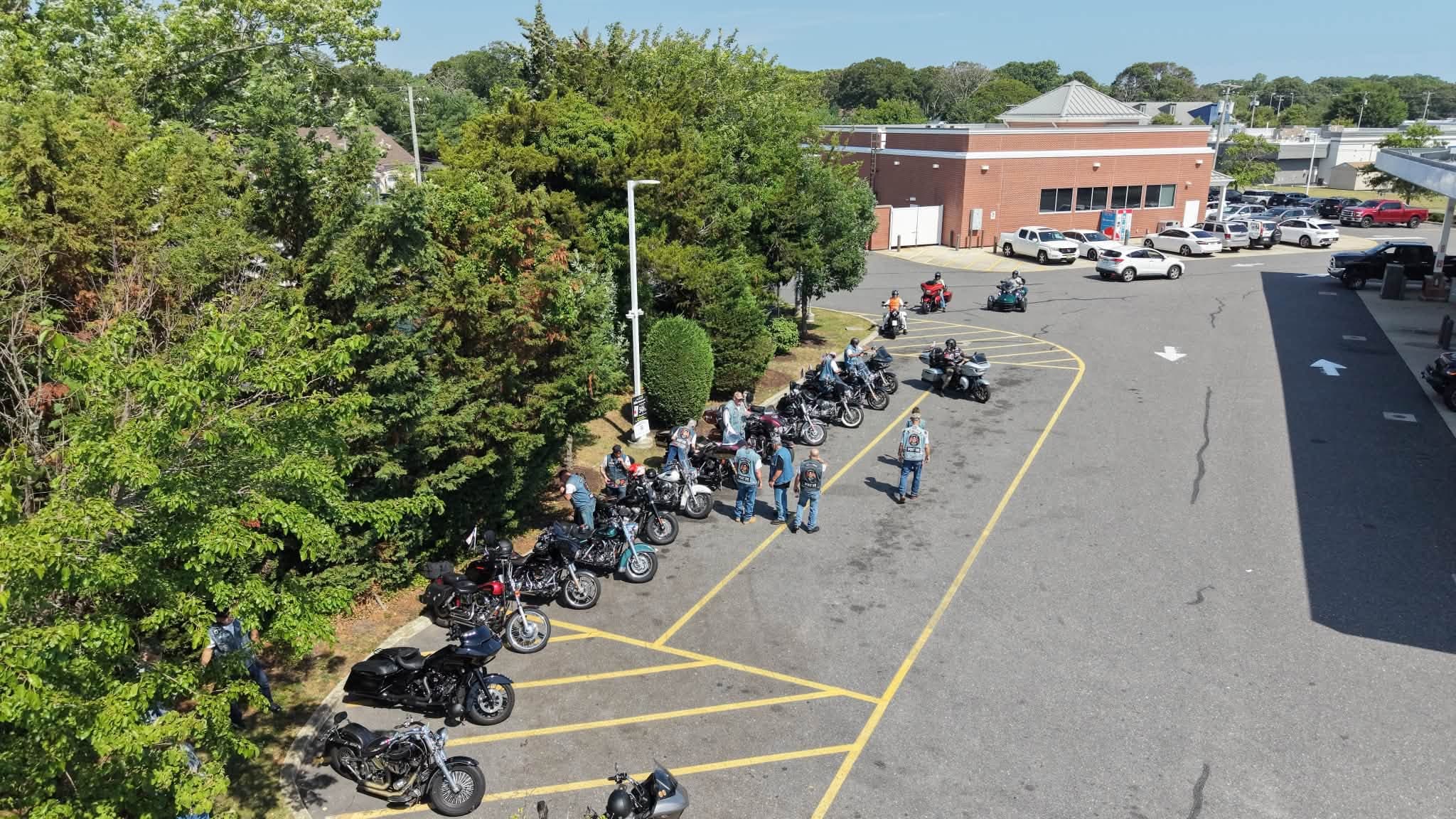 Aerial view of motorcycles lined up in a parking lot before a group ride